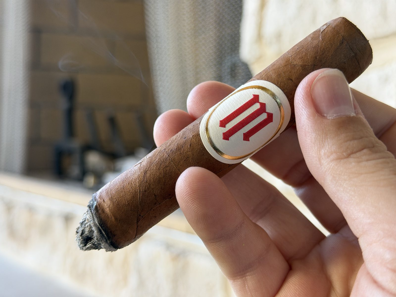 Crowned Heads Mil Días Sublime after the first ash dropped, showing a pointed cone of ligero in the center of the foot