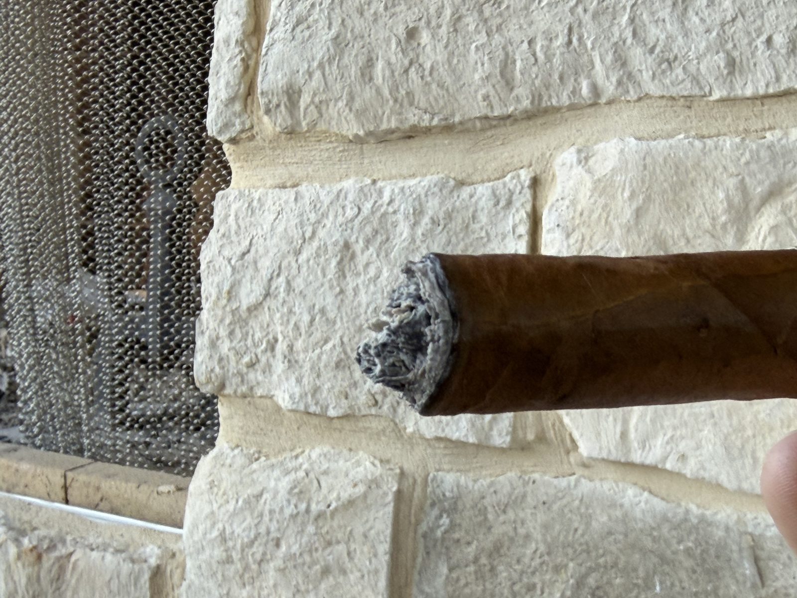 Foot of the Fuente Fuente Opus X Perfecxion X just after ashing, showing an uneven burn line and the slower-burning ligero core sitting low of center