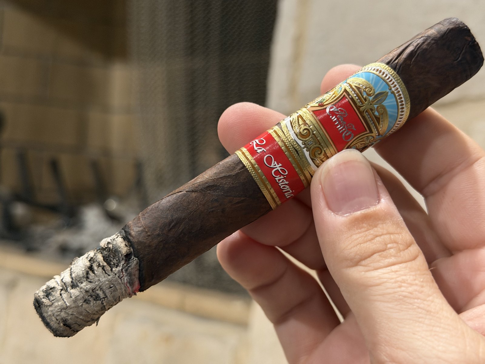 Perez-Carrillo La Historia Doña Elena held in hand with the first-third ash attached, crooked and uneven, both bands still on